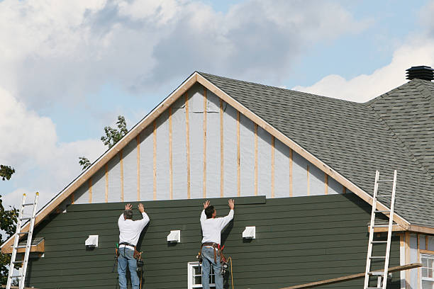 Professional Storm Damage Siding Repair technician working in La Belle, PA